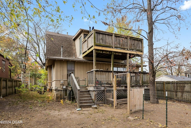 rear view of house featuring a wooden deck