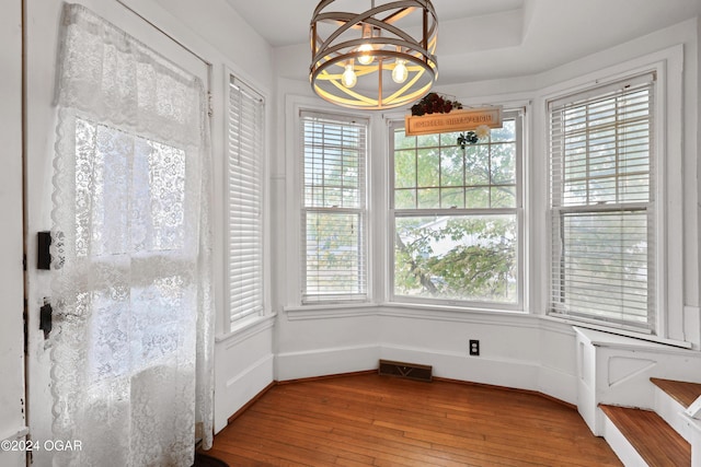 dining area featuring light hardwood / wood-style flooring, a chandelier, and plenty of natural light