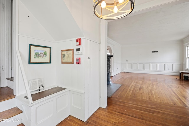 hall featuring hardwood / wood-style floors, a chandelier, and vaulted ceiling