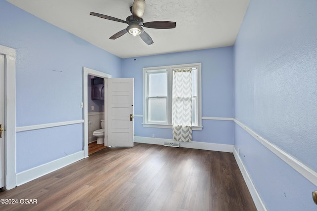 unfurnished bedroom with hardwood / wood-style floors, connected bathroom, and ceiling fan