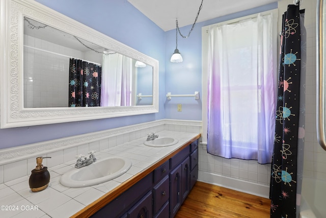 bathroom with vanity, hardwood / wood-style flooring, and walk in shower