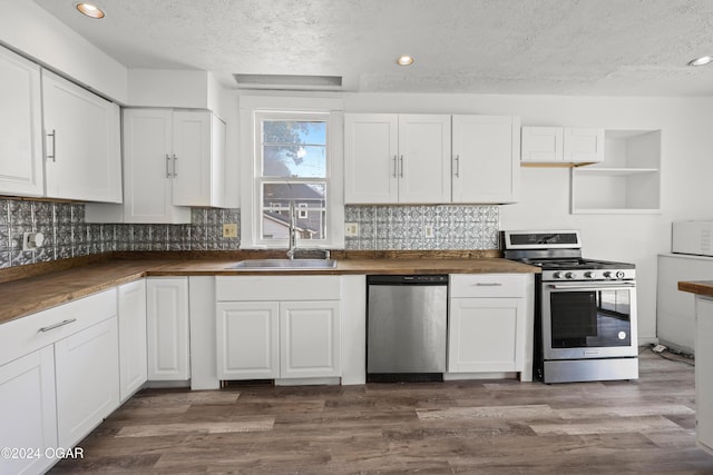 kitchen featuring white cabinetry, a textured ceiling, dark wood-type flooring, sink, and stainless steel appliances