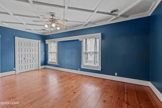 unfurnished bedroom featuring wood-type flooring and coffered ceiling