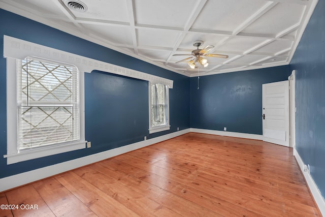 empty room featuring a healthy amount of sunlight, hardwood / wood-style flooring, and coffered ceiling