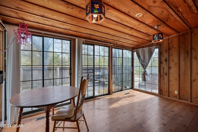 unfurnished sunroom with wooden ceiling and plenty of natural light