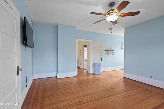 unfurnished room featuring ceiling fan and hardwood / wood-style flooring