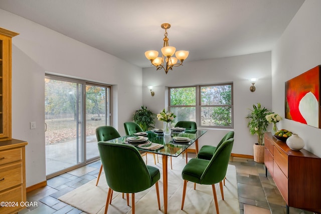 dining area featuring plenty of natural light and a notable chandelier