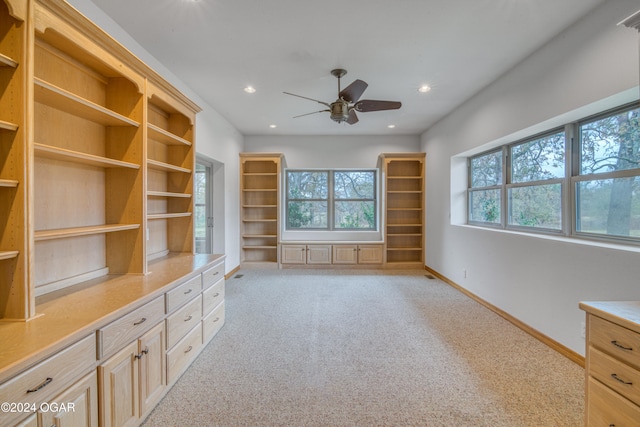 unfurnished living room with light carpet and ceiling fan