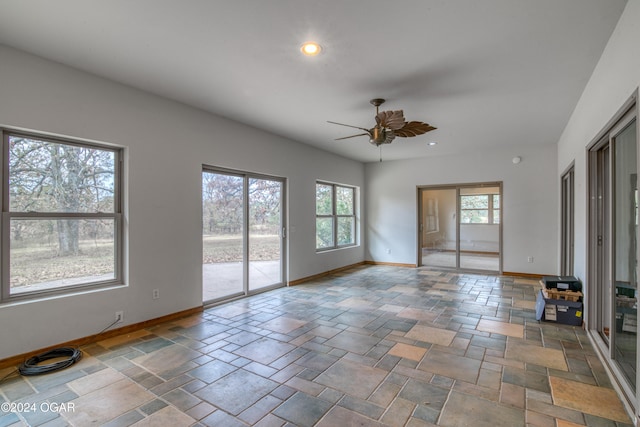 unfurnished living room with ceiling fan