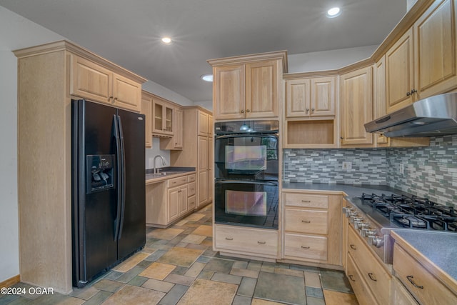 kitchen with light brown cabinets, sink, black appliances, and tasteful backsplash