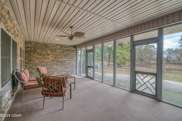 unfurnished sunroom with ceiling fan and wooden ceiling