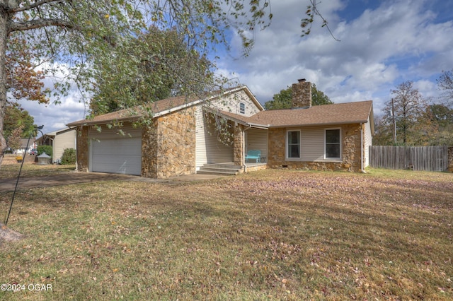 ranch-style house with a front yard and a garage