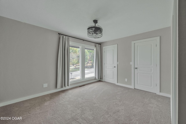 unfurnished bedroom featuring light carpet