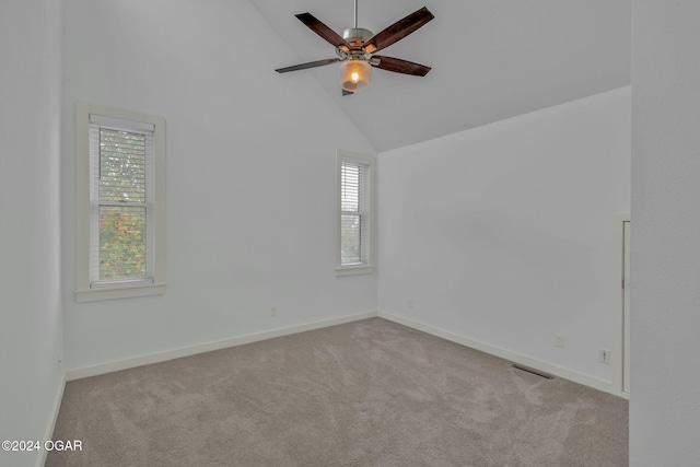 unfurnished room featuring light carpet, high vaulted ceiling, and ceiling fan