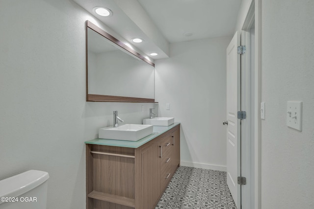 bathroom with vanity, toilet, and tile patterned floors