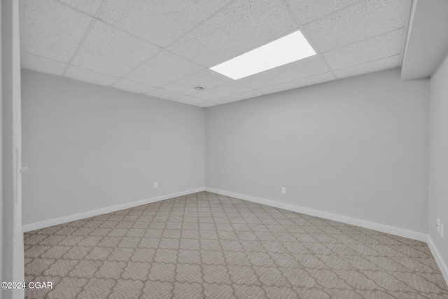 unfurnished room with a drop ceiling