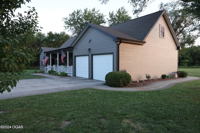 view of property exterior with a garage and a lawn