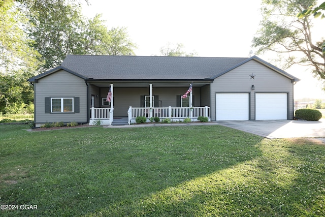 ranch-style house with covered porch, a garage, and a front yard