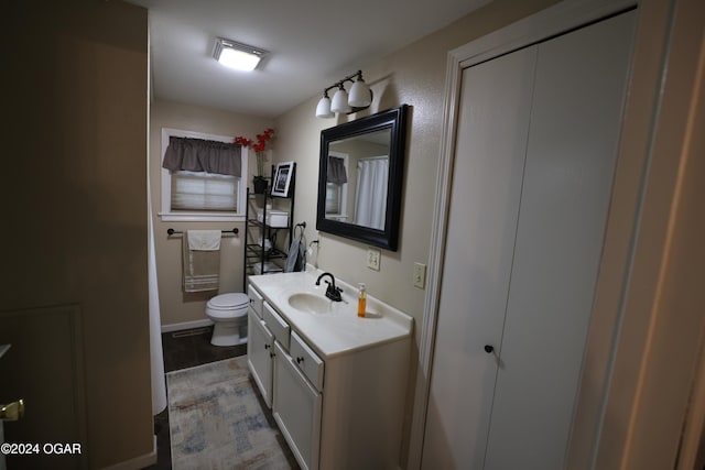 bathroom featuring vanity, toilet, and tile patterned floors