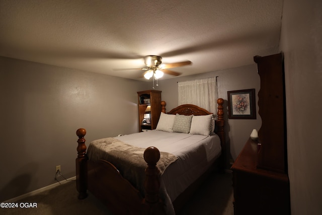 bedroom featuring dark colored carpet, a textured ceiling, and ceiling fan