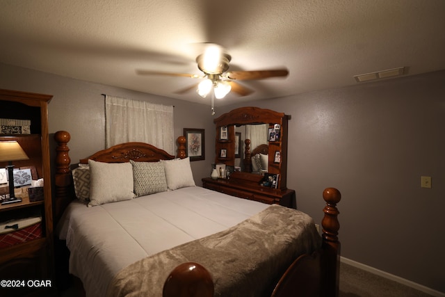 carpeted bedroom with a textured ceiling and ceiling fan