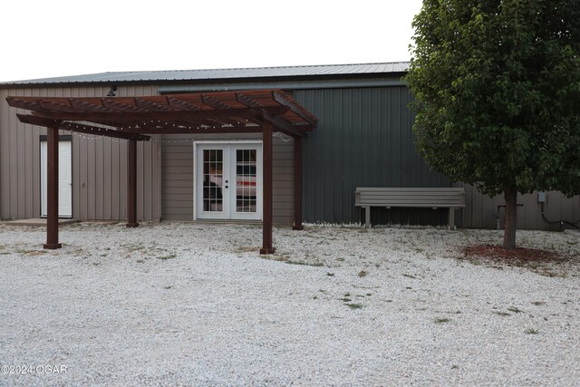 exterior space featuring french doors and a carport