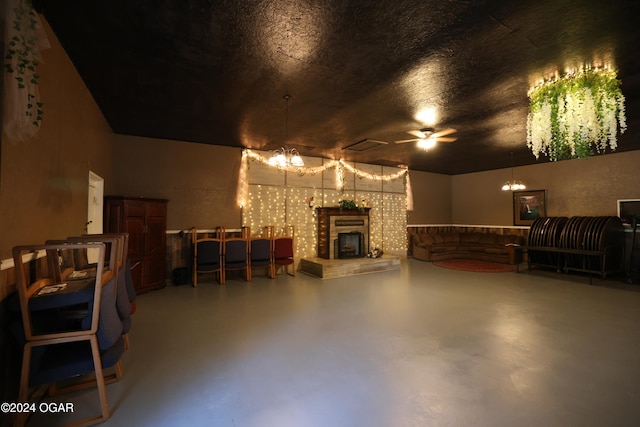 living room featuring an inviting chandelier and concrete floors