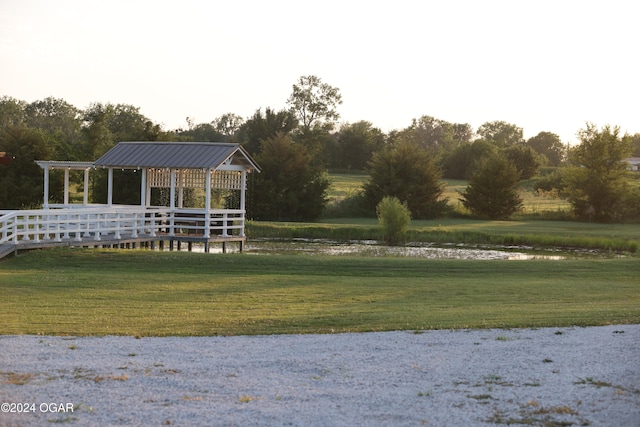 view of home's community featuring a yard and a water view