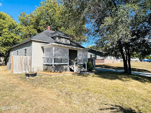 bungalow with a wooden deck and a front yard