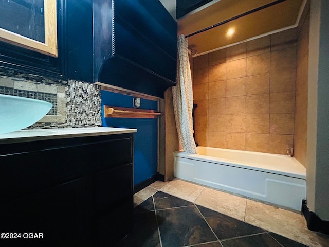 bathroom with tasteful backsplash, shower / bath combination with curtain, tile patterned floors, and vanity