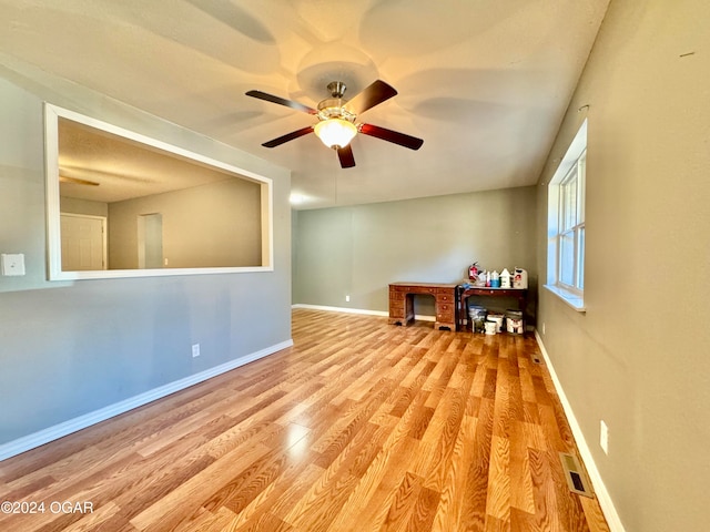 spare room featuring light wood-type flooring and ceiling fan