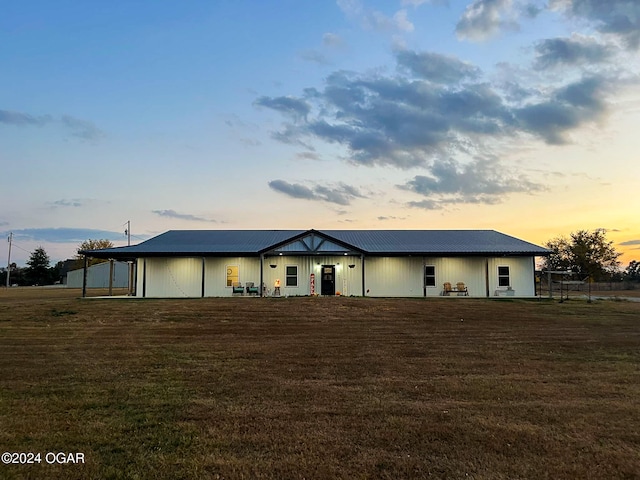 view of front of home featuring metal roof and a front lawn