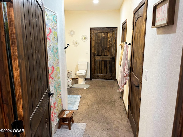 bathroom featuring curtained shower and toilet