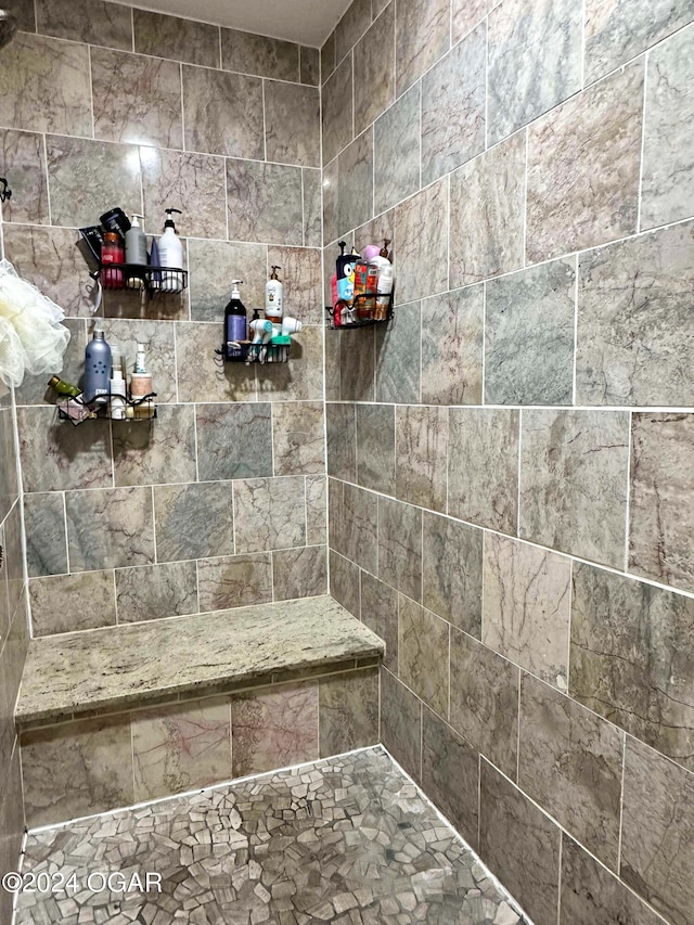 bathroom with a tile shower