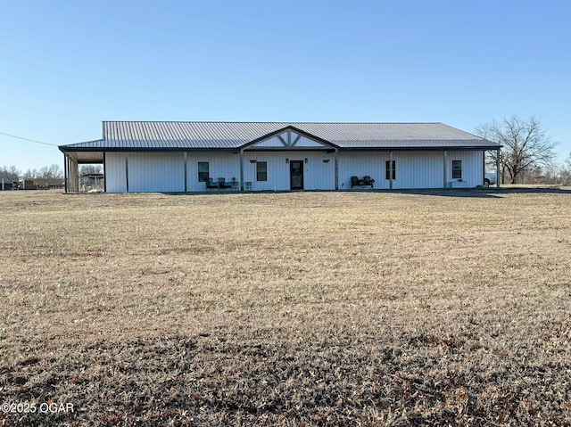 view of front of home featuring a front yard and metal roof