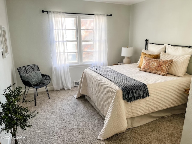 bedroom featuring light colored carpet