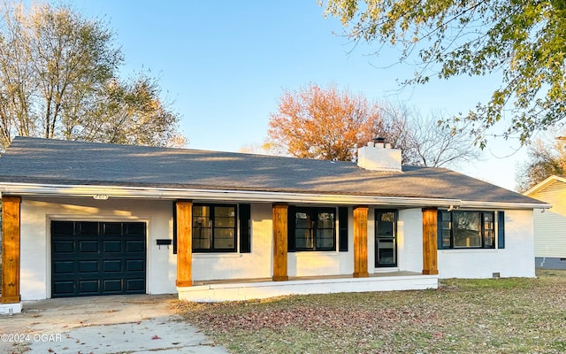 ranch-style home featuring a porch and a garage