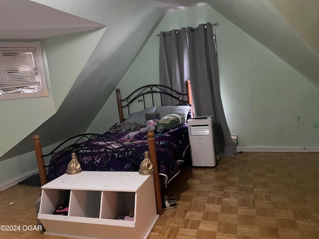 bedroom featuring parquet flooring and vaulted ceiling