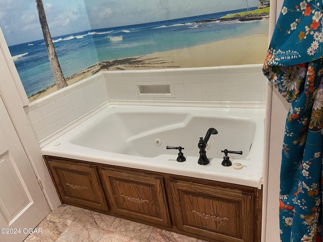 bathroom featuring a tub to relax in and a water view