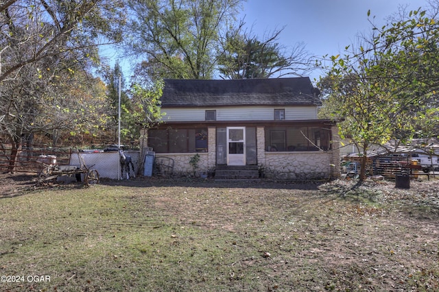 view of front of house featuring a front yard and a sunroom