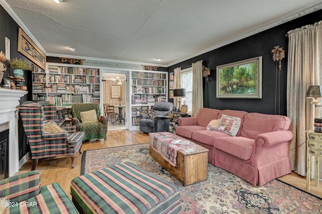 living area featuring light wood-style floors, a fireplace, crown molding, and a textured ceiling