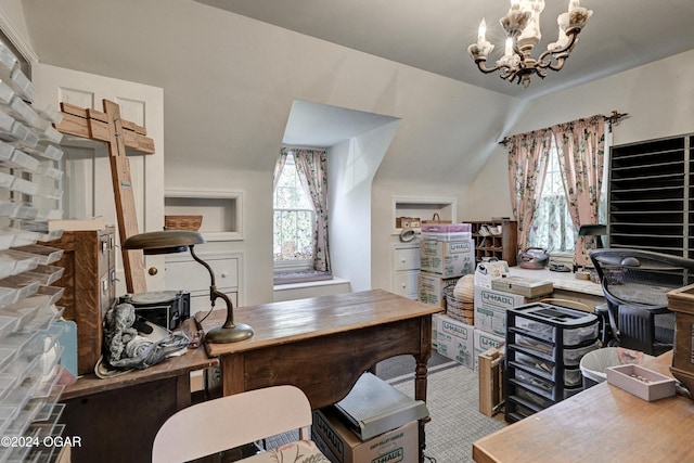 office featuring lofted ceiling, a healthy amount of sunlight, and an inviting chandelier