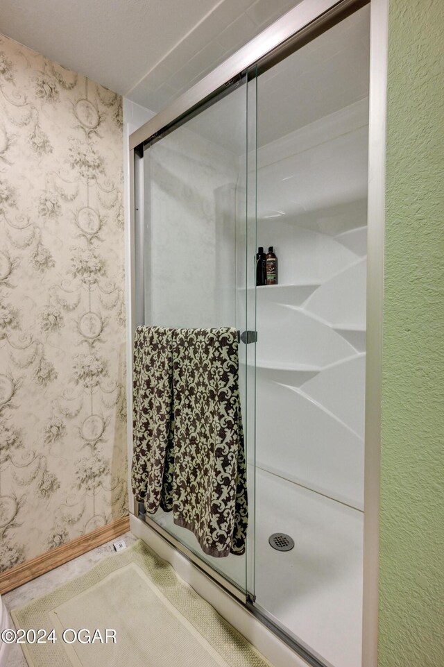 114 W F St, Joplin, MO 64801 - full bathroom with a shower stall, wallpapered walls, and baseboards