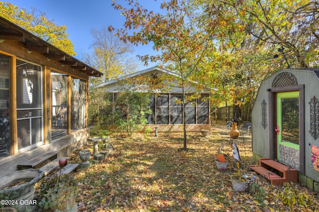 view of yard with fence and a sunroom