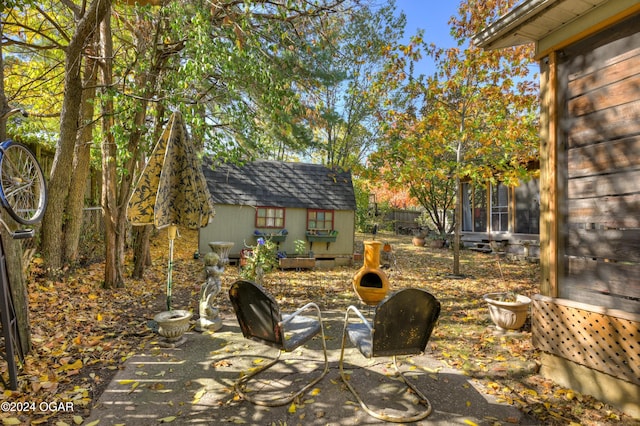 view of patio featuring a storage shed and an outbuilding