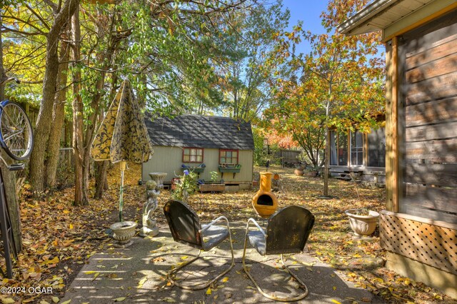 114 W F St, Joplin, MO 64801 - view of patio / terrace featuring a storage shed and an outdoor structure