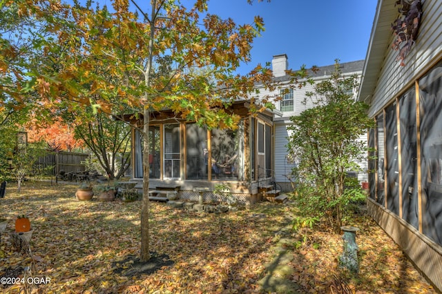 view of yard with a sunroom and a fenced backyard