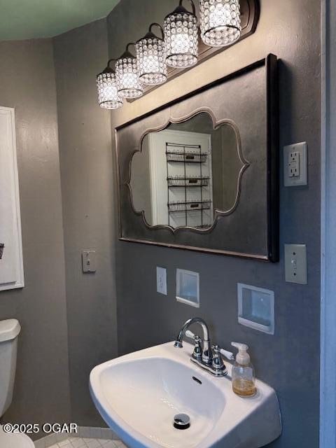 bathroom with toilet and a sink