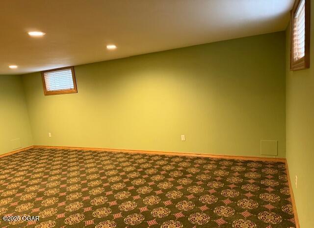 below grade area featuring carpet floors, baseboards, and recessed lighting