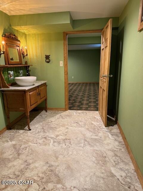 bathroom featuring vanity and baseboards